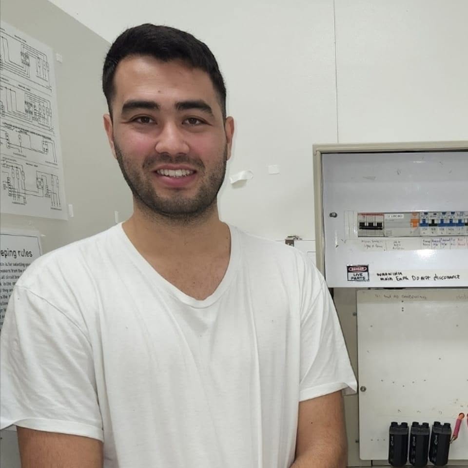 Leo Young, owner of Cablecore Electrical, beside a switchboard