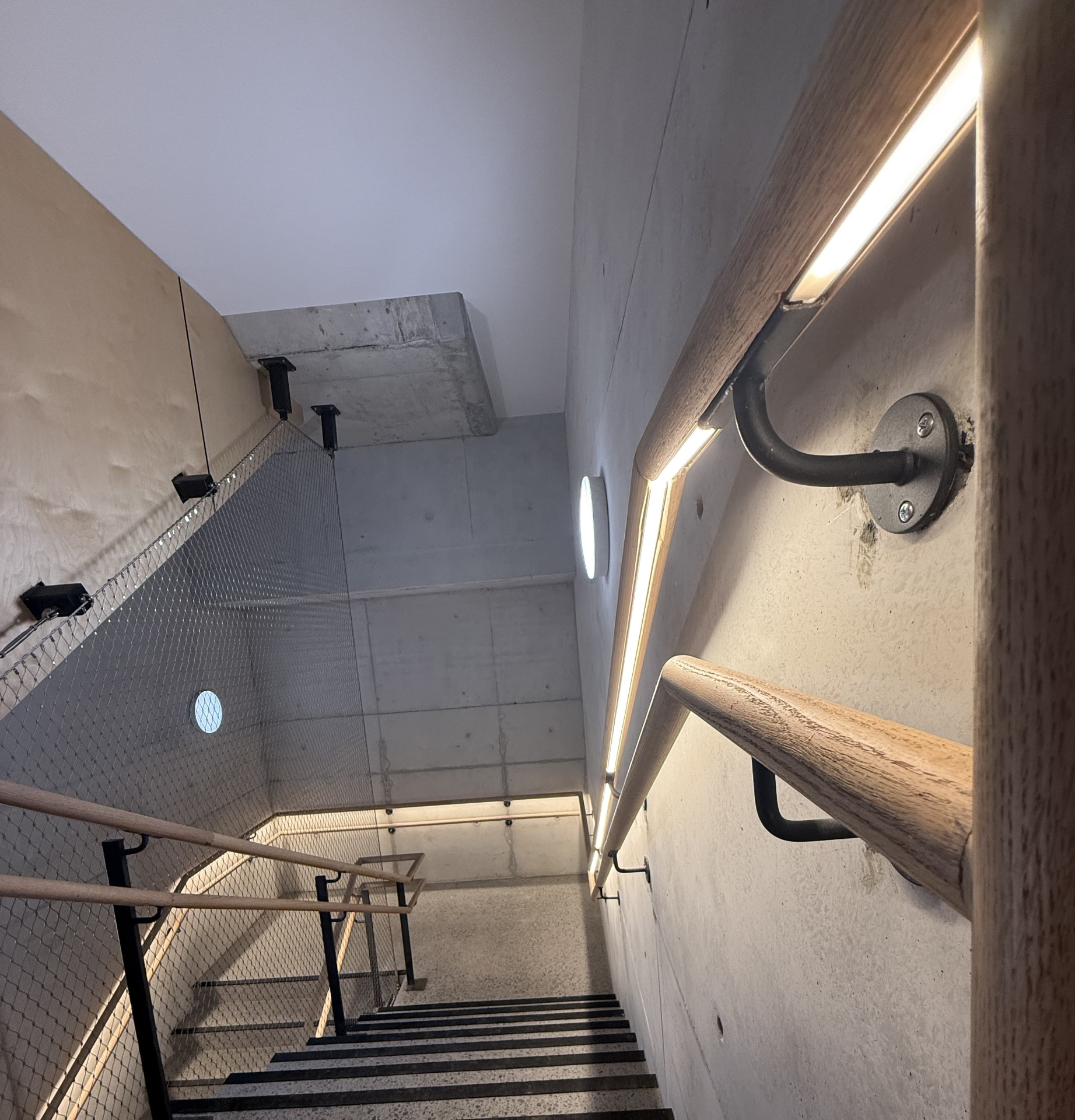 LED strip lighting integrated into timber stairwell handrails